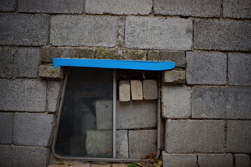 bus window on the facade wall of cinder block