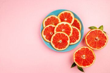 top view tasty grapefruits fruit slices inside plate on a pink background mellow fresh citrus fruit juice color diet