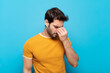 © kues1 - young handsome man feeling stressed, unhappy and frustrated, touching forehead and suffering migraine of severe headache
