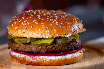 Lunch or dinner with tasty vegetarian hamburgers made from plant based grilled burgers, fresh bakes buns and organic vegetables