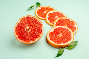 front view tasty fresh grapefruits on light-blue background health fruit diet fresh juice color