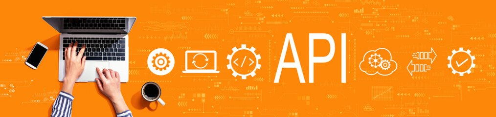 API - application programming interface concept with person using a laptop computer