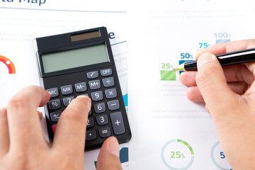 Canvas Print - Close-up of hands of financial accountant using calculator