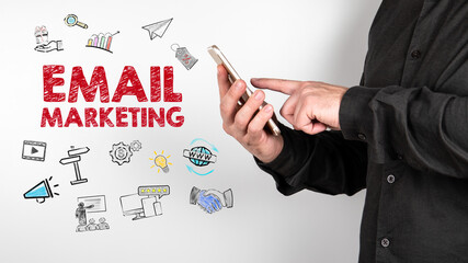 Wall Mural - Email Marketing concept. Man with a cell phone in hands