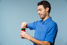 Joyful Handsome Guy Smiling While Opening Soda Can