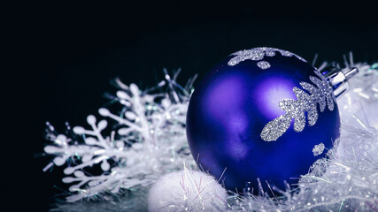 blue Christmas ball on a black background.Christmas card