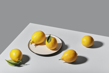 Trending colors of 2021. Yellow illuminating lemons on Ultimate gray tablecloth. Isometric view minimal still life