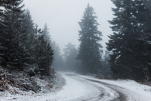 Snowy Mountain Road On A Foggy Early Morning