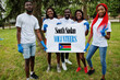 © AS Photo Family - Group of happy african volunteers hold blank with South Sudan flag in park. Africa countries volunteering, charity, people and ecology concept.