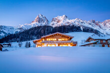 Wooden Chalet In The Alps On A Cold Winter Evening
