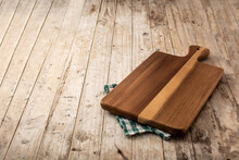 Cutting Board Mockup And Green Tablecloth On Wooden Table. Copy Space