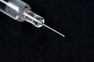 Wall Mural - syringe isolated on black background