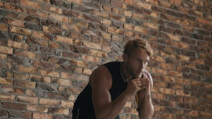 Wall Mural - A focused man is training standing isolated over a brick wall