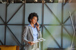 © Mamika - African American businesswoman talking on cell phone in the office.