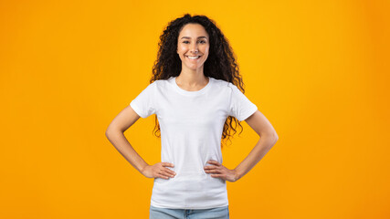 Wall Mural - Cheerful Woman Standing Holding Hands On Hips, Studio Shot, Panorama