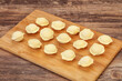 Raw dumplings over board for cooking