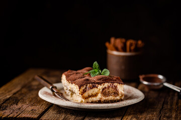 Wall Mural - Piece of traditional Italian dessert tiramisu on dark background