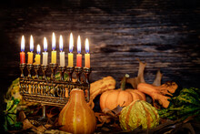 Kwanzaa Holiday With Decorate Candles And Pumpkin On Wooden Background