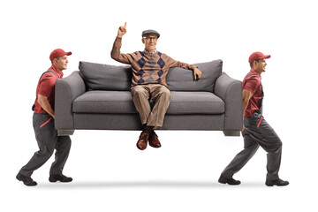 Wall Mural - Movers carrying an elderly man sitting on a sofa and pointing up