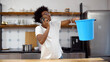 © nimito - African man having water leaking from ceiling and calling plumber