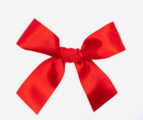 Red ribbon bow for gifts to Christmas day celecration, surprise, close up view isolated on a white background