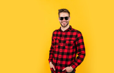 he is really cute. confident and calm. handsome casual man standing with beard and bristle. cheerful and stylish. handsome man in sunglasses. indoor portrait of sexy european businessman. copy space