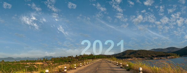 Wall Mural - Nature landscape with asphalt road leading forward to happy new year 2021. Concept of start new year 2021.