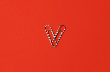 Heart shape paper clips on a red background. Valentine's day concept. High quality photo