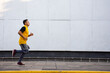 © ERNESTO - Young athletic man running on the street