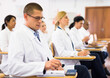 © JackF - Portrait of confident man doctor listening to lecture within refresher course. Professional development concept