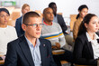 © JackF - Portrait of focused businessman attending business conference, listening with interest to speaker