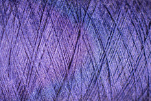 Background Of A Close Up Of Purple   Thread For Sewing Fabric: Seamless Pattern Of Twisted Thread In A Trendy Color, Soft Focus, Selective Focus, Space For Text