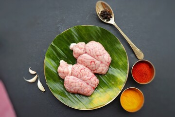 Wall Mural - Uncooked Goat brain or Bheja or Mutton Brain.Perfect to cook bheja fry or bheja masala. Indian cooking ingredients. Copy space.