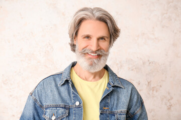 Canvas Print - Stylish mature man with grey hair on light background