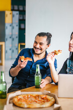 Latin Man Eating Pizza And Drinking Beer In Office At Mexico City Happy Hour