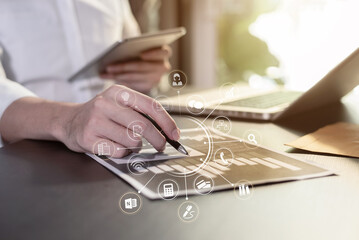 Business documents on the desk with a notebook and business graph graph with office icons in the morning. 