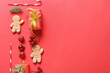 © Pixel-Shot - Christmas holiday celebration with gingerbread cookies, gift boxes, candy canes, and ornaments on red background