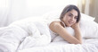 © lenetsnikolai - beautiful young woman basking in bed in the morning. Beautiful Model face looks sexy in camera
