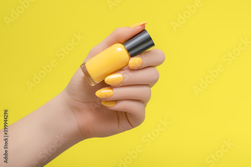 Female hand with yellow nail design Lerretsbilde