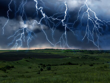 Dark Cloudy Sky With Lightnings. Picturesque Thunderstorm Over Field