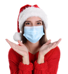 Canvas Print - Pretty woman in Santa hat and medical mask on white background