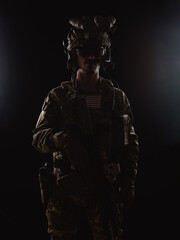 Delta Force soldier, US army special forces. Combat application group, Army compartmented element operator - Tier 1. Portrait on a black backdrop with rifle and night vision.