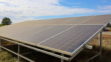 Wall Mural - Dusty Solar Panels. Soil dust accumulates on the outdoor solar panel surface. Resulting in lower efficiency of light energy conversion On the background the sky is white clouds. Selective focus