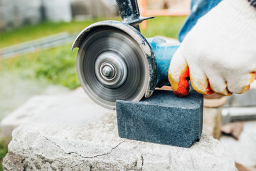 Wall Mural - Sharp diamond blade on a powerful electric grinder with high rotation speeds - close-up cutting of stone