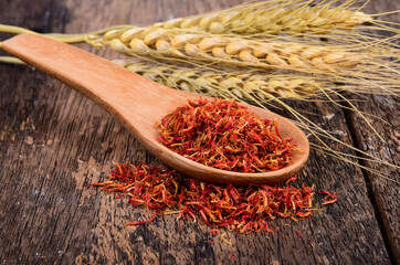 Wall Mural - Safflower in wood spoon on wooden