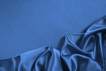 blue silk satin fabric background. copy space for your design. delicate wavy folds. beautiful elegan