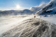 © robertharding - Man rejoices on icy empty road along Barents Sea during the Arctic windstorm, Berlevag, Varanger Peninsula, Finnmark