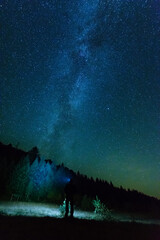 Wall Mural - fantastic starry night with galaxy milky way with a tourist and a tent on the mountain range in the 