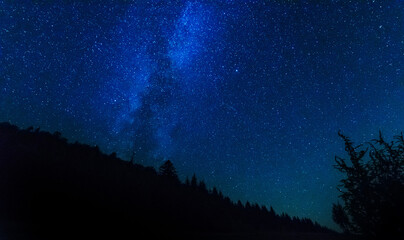Wall Mural - fantastic starry night with galaxy milky way with a tourist and a tent on the mountain range in the 
