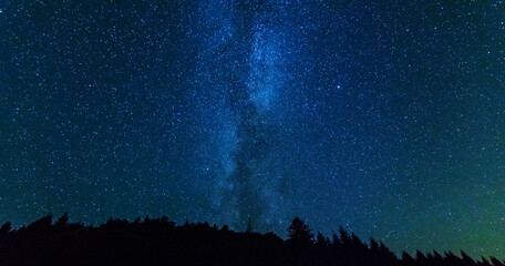 Wall Mural - fantastic starry night with galaxy milky way with a tourist and a tent on the mountain range in the 